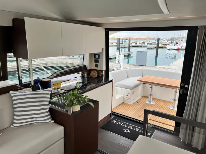  Yacht Photos Pics Luxurious interior of 2023 Prestige 460 Flybridge yacht with modern kitchen and marina view.