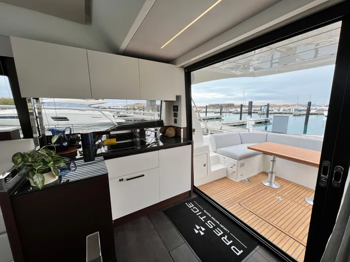  Yacht Photos Pics Prestige 460 Flybridge 2023 yacht interior with modern kitchen and outdoor seating area.