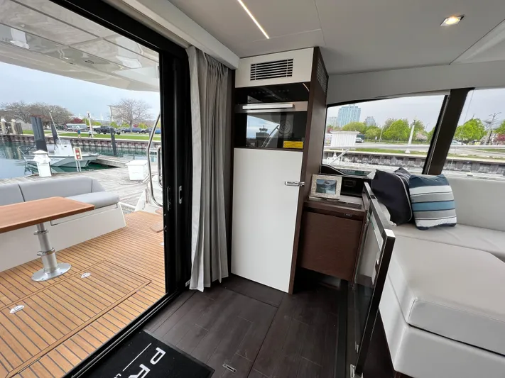  Yacht Photos Pics Interior of 2023 Prestige 460 Flybridge yacht with modern design and outdoor seating area.