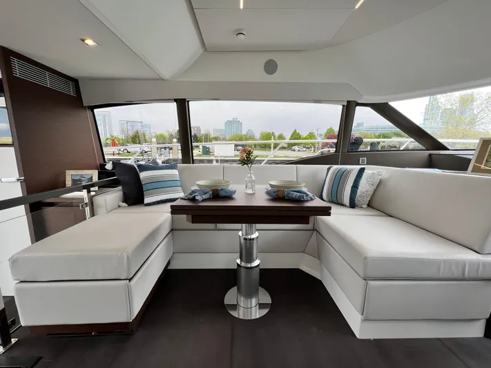  Yacht Photos Pics Luxurious interior of 2023 Prestige 460 Flybridge yacht with elegant seating and dining area.