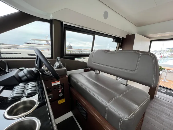  Yacht Photos Pics Interior of 2023 Prestige 460 Flybridge yacht, featuring helm station and seating.