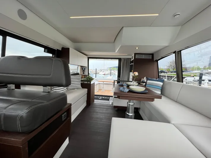  Yacht Photos Pics Luxurious interior of 2023 Prestige 460 Flybridge yacht with modern seating and dining area.