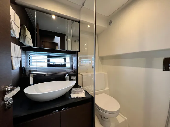  Yacht Photos Pics Luxurious bathroom in 2023 Prestige 460 Flybridge yacht with modern fixtures and elegant design.