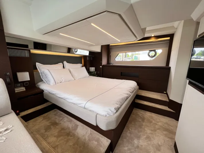 Yacht Photos Pics Luxurious bedroom interior of 2023 Prestige 460 Flybridge yacht, featuring elegant design and modern amenities.