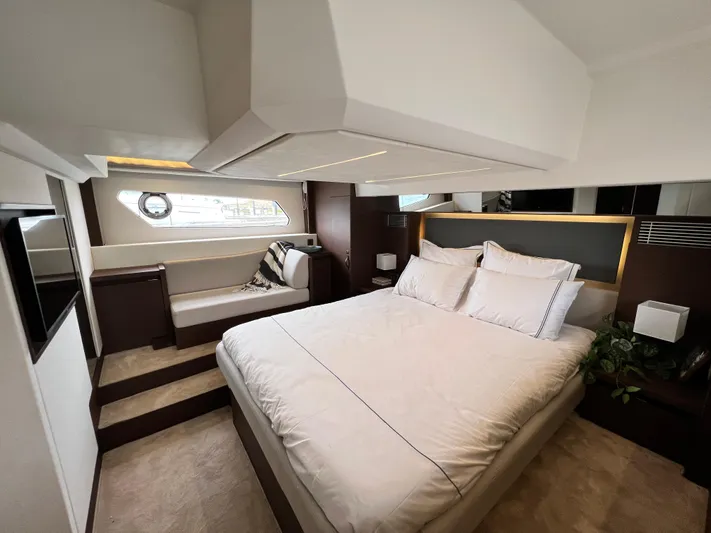  Yacht Photos Pics Luxurious bedroom interior of 2023 Prestige 460 Flybridge yacht with elegant design and cozy bedding.