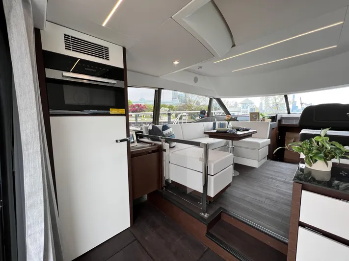  Yacht Photos Pics Luxurious interior of 2023 Prestige 460 Flybridge yacht with modern seating and elegant design.