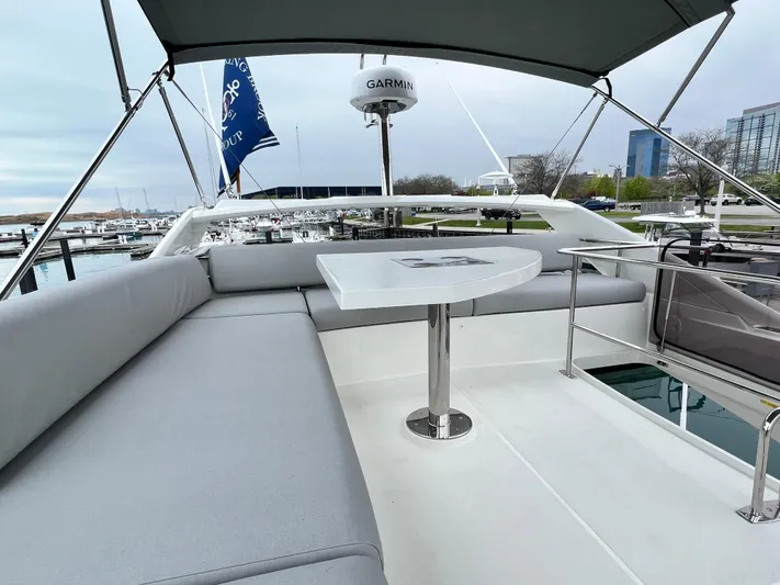  Yacht Photos Pics Prestige 460 Flybridge 2023 yacht with spacious seating and table, docked at marina.