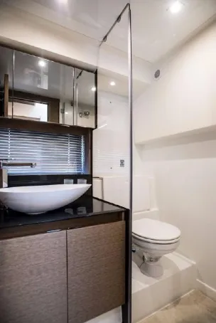  Yacht Photos Pics Modern bathroom in 2023 Prestige 460 Flybridge yacht with sleek design and vessel sink.