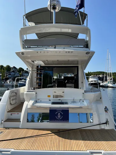  Yacht Photos Pics 2023 Prestige 460 Flybridge yacht docked at marina, rear view.