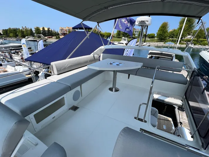  Yacht Photos Pics Prestige 460 Flybridge 2023 yacht with spacious seating and table on deck, docked at marina.