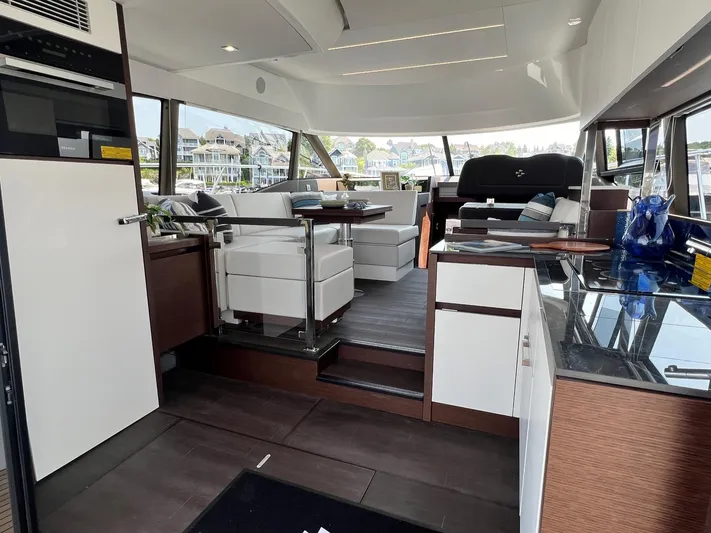  Yacht Photos Pics Luxurious interior of 2023 Prestige 460 Flybridge yacht with modern furnishings and panoramic windows.