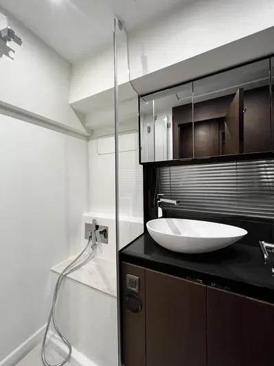  Yacht Photos Pics Modern bathroom in 2023 Prestige 460 Flybridge yacht with sleek fixtures and vessel sink.