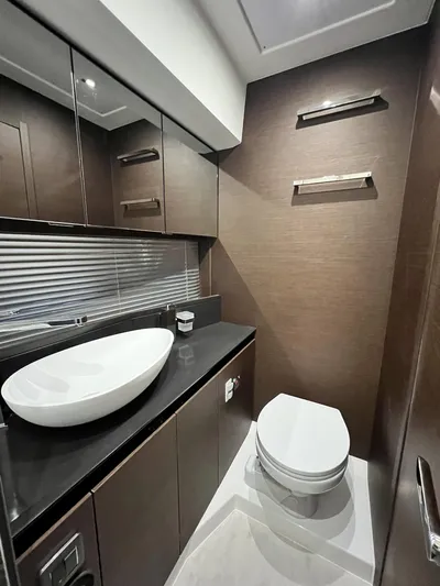  Yacht Photos Pics Luxurious bathroom in 2023 Prestige 460 Flybridge yacht with modern fixtures and elegant design.