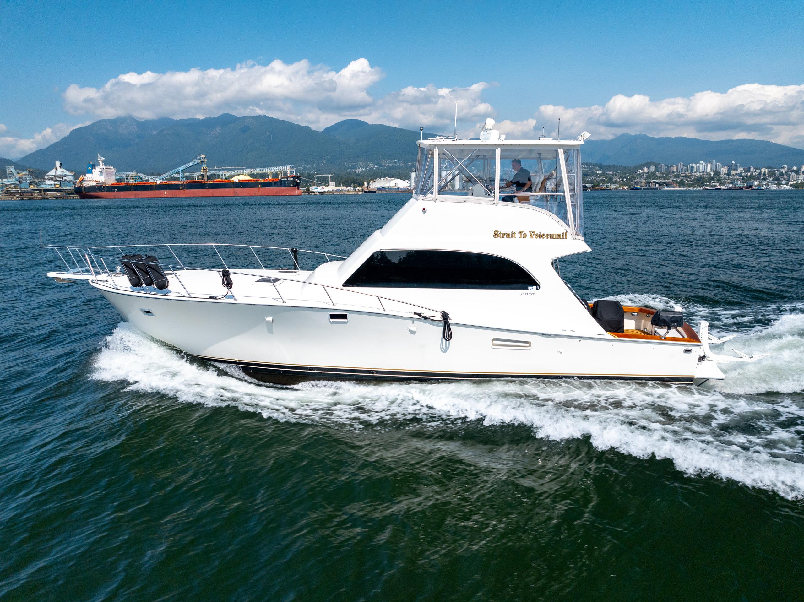 1985 Post 46 Convertible yacht cruising on water.