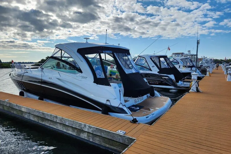  Yacht Photos Pics 2012 Cruisers Yachts 380 Express docked at marina under partly cloudy sky.