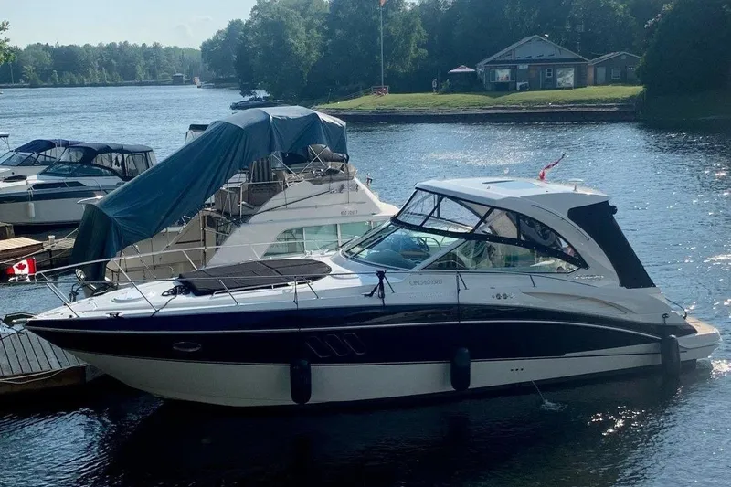  Yacht Photos Pics 2012 Cruisers Yachts 380 Express docked on a serene lake.