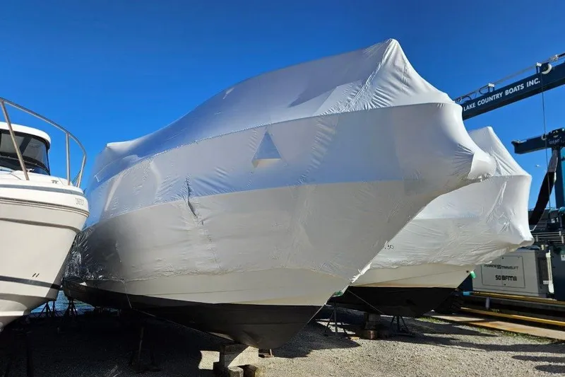  Yacht Photos Pics 2012 Cruisers Yachts 380 Express covered in protective wrap, stored outdoors.