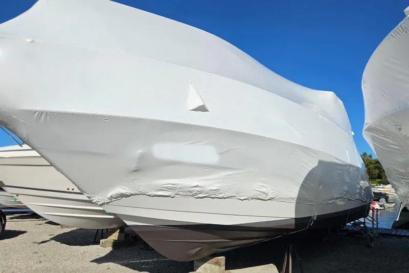  Yacht Photos Pics 2012 Cruisers Yachts 380 Express covered in protective wrap, docked outdoors.