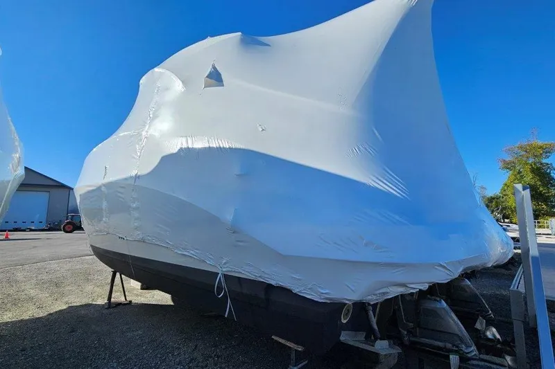  Yacht Photos Pics 2012 Cruisers Yachts 380 Express covered in protective wrap, parked outdoors.