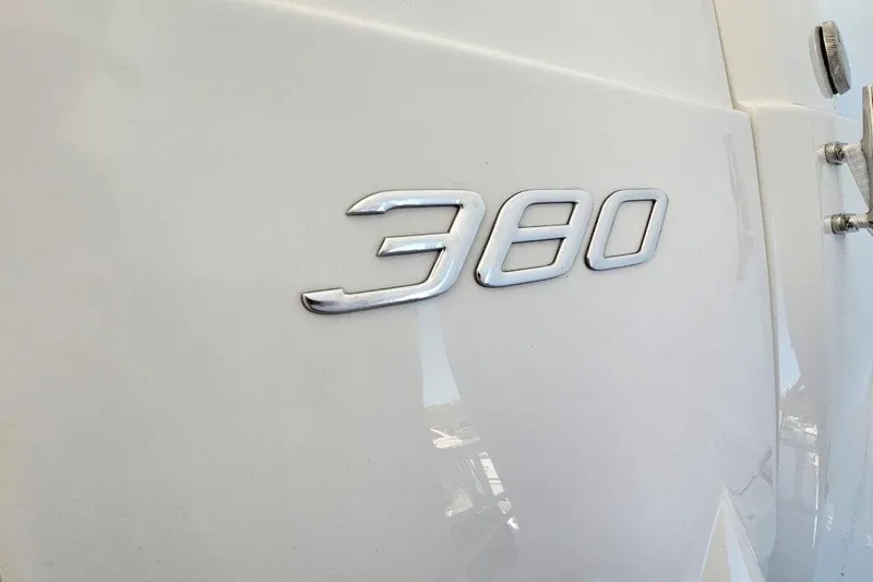  Yacht Photos Pics Close-up of 2012 Cruisers Yachts 380 Express emblem on white surface.