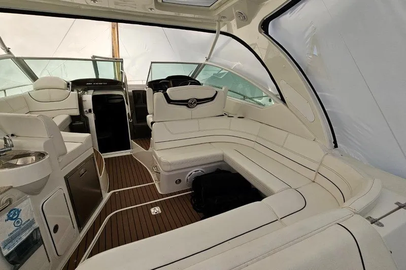  Yacht Photos Pics Luxurious interior of 2012 Cruisers Yachts 380 Express with white seating and wood flooring.