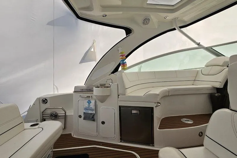  Yacht Photos Pics Luxurious interior of 2012 Cruisers Yachts 380 Express with white seating and wood accents.