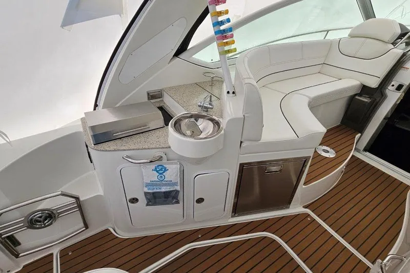  Yacht Photos Pics 2012 Cruisers Yachts 380 Express interior with seating, sink, and wooden flooring.