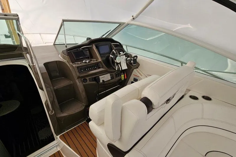  Yacht Photos Pics 2012 Cruisers Yachts 380 Express helm with white seating and modern controls.