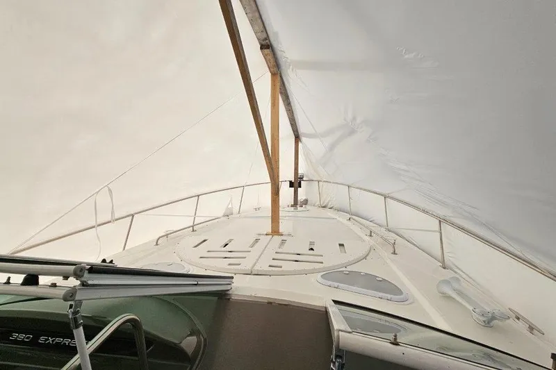  Yacht Photos Pics 2012 Cruisers Yachts 380 Express under protective cover, showcasing deck and railing.