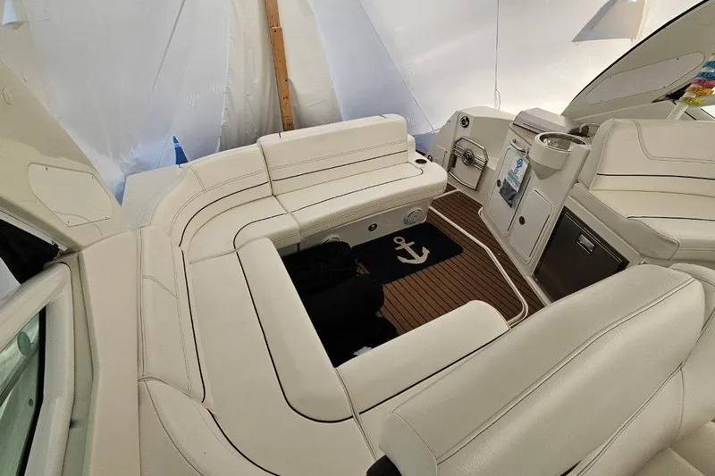  Yacht Photos Pics Luxurious interior of 2012 Cruisers Yachts 380 Express with white seating and wood flooring.