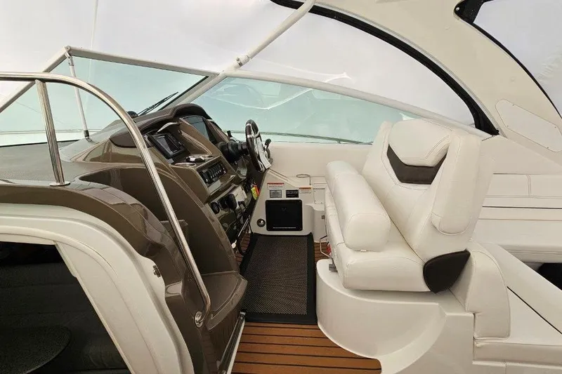  Yacht Photos Pics 2012 Cruisers Yachts 380 Express cockpit with white seating and modern dashboard.