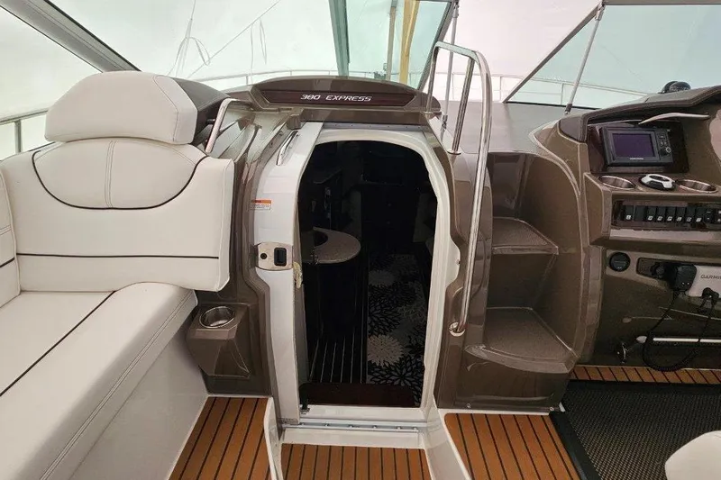  Yacht Photos Pics 2012 Cruisers Yachts 380 Express interior with helm, seating, and cabin entrance.