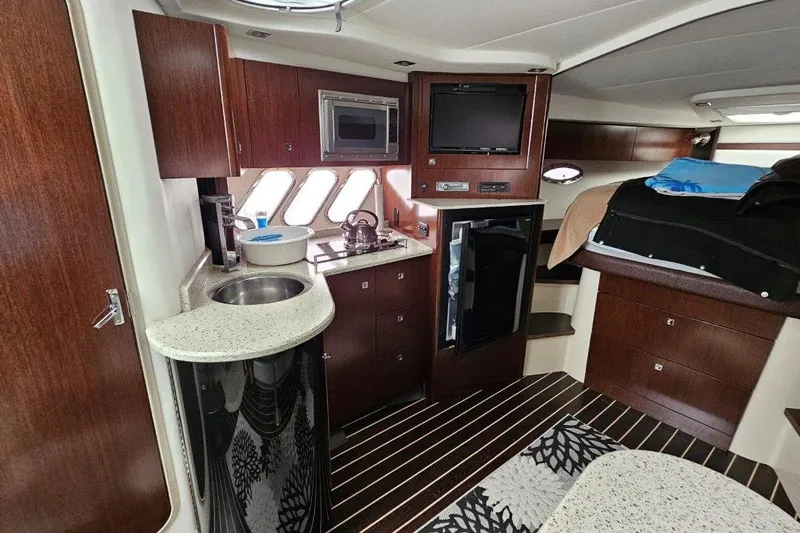  Yacht Photos Pics Interior of 2012 Cruisers Yachts 380 Express with kitchenette and cozy sleeping area.