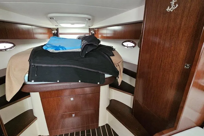  Yacht Photos Pics Interior cabin of 2012 Cruisers Yachts 380 Express with wooden finish and bedding.