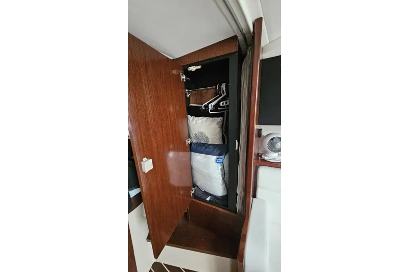  Yacht Photos Pics Open wooden closet in 2012 Cruisers Yachts 380 Express, with pillows and hangers inside.