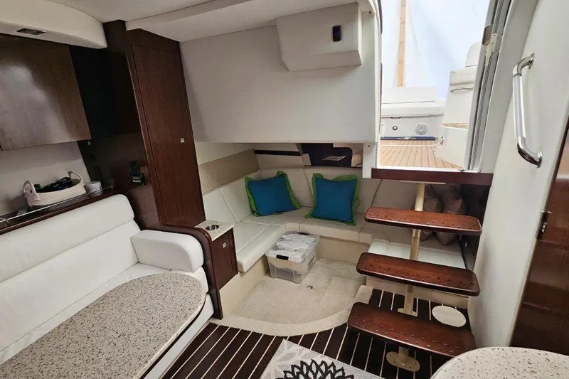  Yacht Photos Pics Interior of 2012 Cruisers Yachts 380 Express with cozy seating and wooden accents.