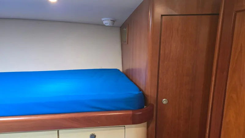 Rack Em Up Yacht Photos Pics Interior cabin of 2008 Ocean Yachts 37 Billfish with blue bedding.