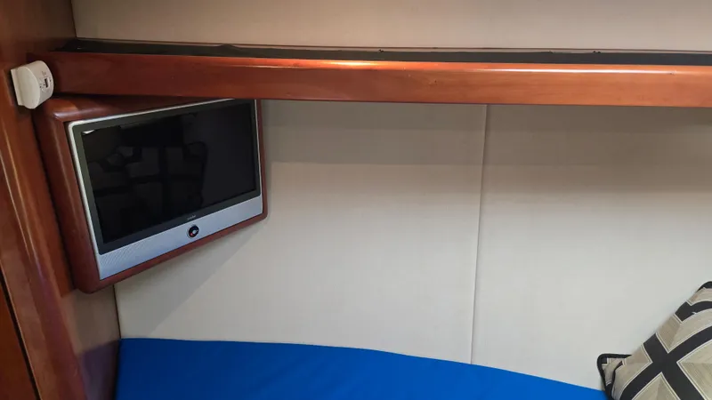 Rack Em Up Yacht Photos Pics Interior of 2008 Ocean Yachts 37 Billfish with TV and blue bedding.