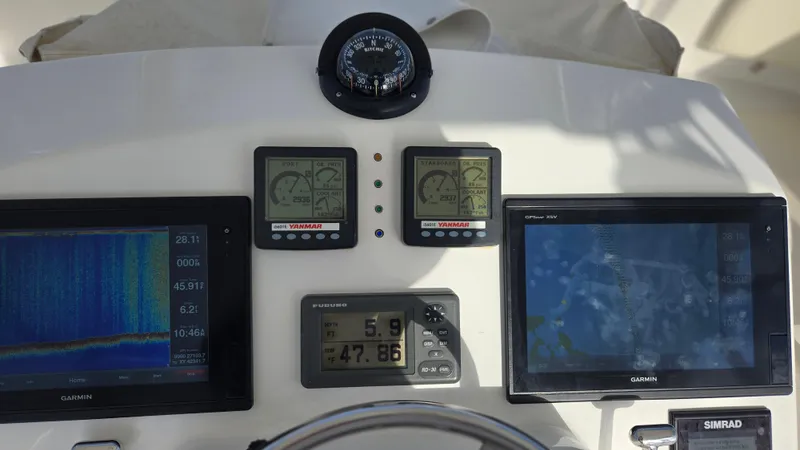 Rack Em Up Yacht Photos Pics Control panel of 2008 Ocean Yachts 37 Billfish with navigation and monitoring displays.