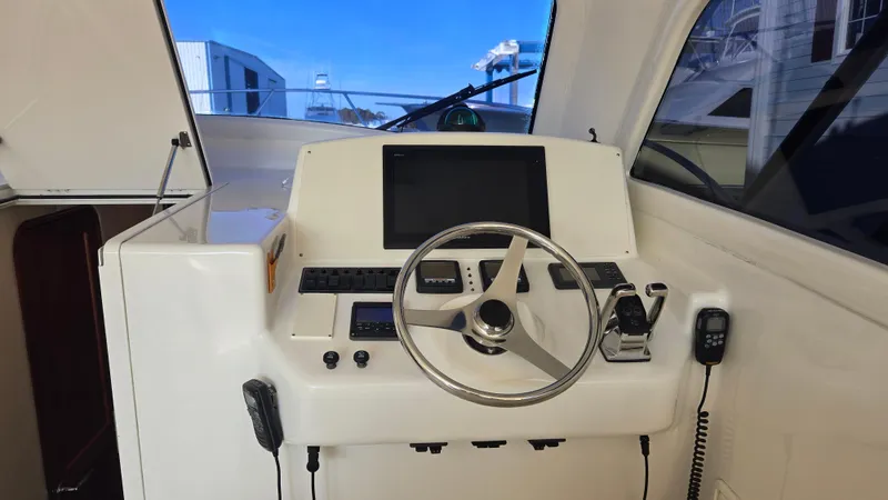Rack Em Up Yacht Photos Pics Helm of 2008 Ocean Yachts 37 Billfish with steering wheel and navigation controls.