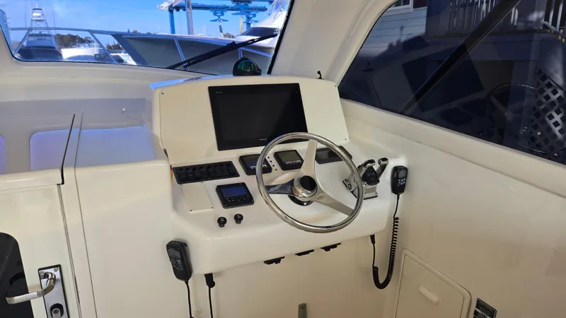 Rack Em Up Yacht Photos Pics Helm of 2008 Ocean Yachts 37 Billfish with steering wheel and navigation controls.