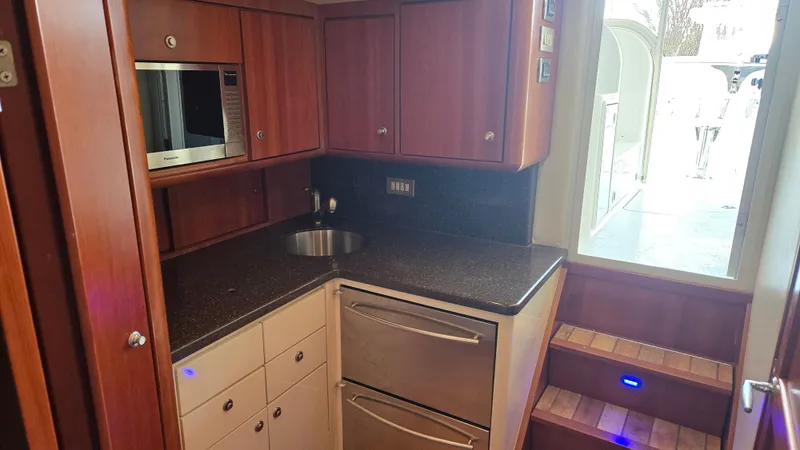 Rack Em Up Yacht Photos Pics Luxurious kitchen in 2008 Ocean Yachts 37 Billfish with modern appliances and wood cabinetry.