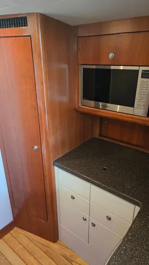 Rack Em Up Yacht Photos Pics Interior of 2008 Ocean Yachts 37 Billfish with wood cabinetry and built-in microwave.