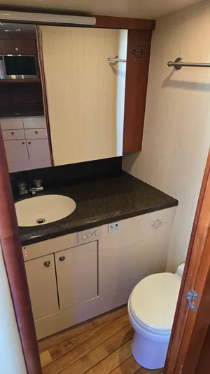 Rack Em Up Yacht Photos Pics Bathroom interior of 2008 Ocean Yachts 37 Billfish with sink and toilet.