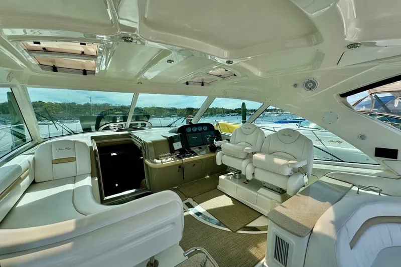  Yacht Photos Pics Luxurious interior of 2008 Sea Ray 48 Sundancer yacht with plush seating and modern helm.