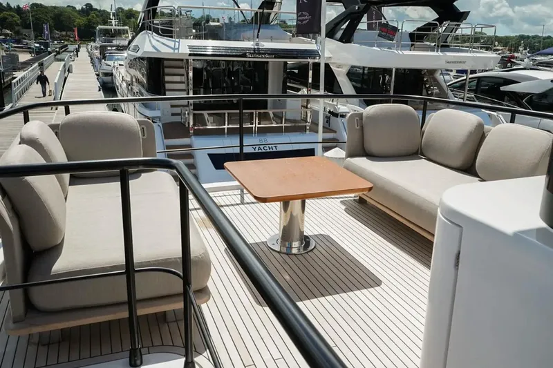  Yacht Photos Pics Luxurious 2024 Azimut Magellano 60 yacht deck with elegant seating and table.