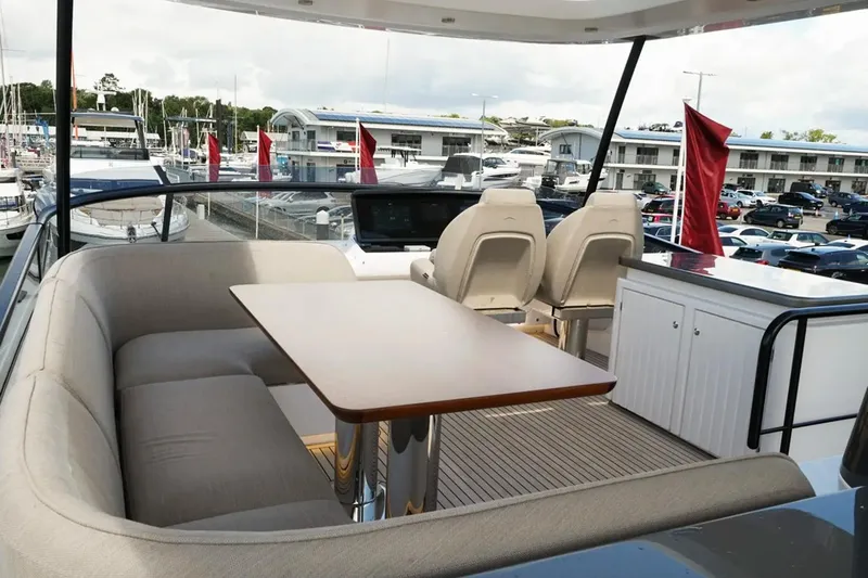  Yacht Photos Pics Luxurious seating area on 2024 Azimut Magellano 60 yacht, featuring elegant design and marina view.