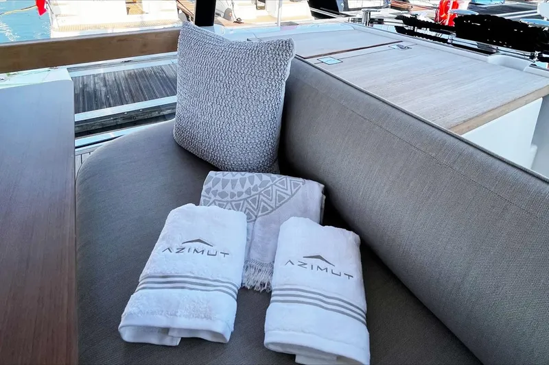 Yacht Photos Pics Luxurious seating area on 2024 Azimut Magellano 60 yacht with branded towels.