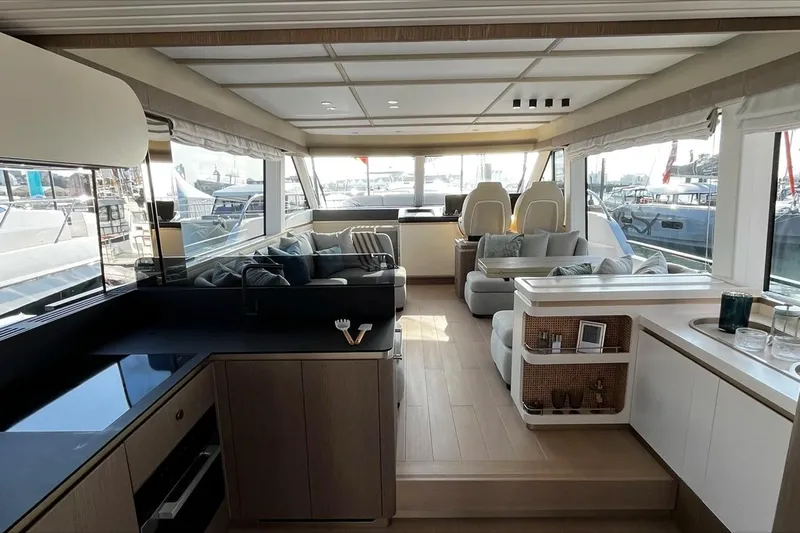 Yacht Photos Pics Luxurious interior of 2024 Azimut Magellano 60 yacht with modern furnishings and panoramic windows.