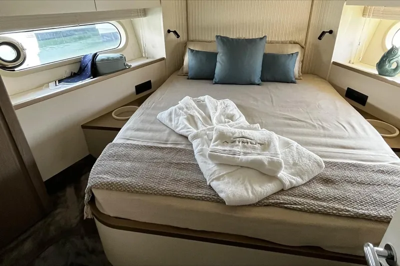  Yacht Photos Pics Luxurious bedroom interior of 2024 Azimut Magellano 60 yacht with elegant bedding and decor.